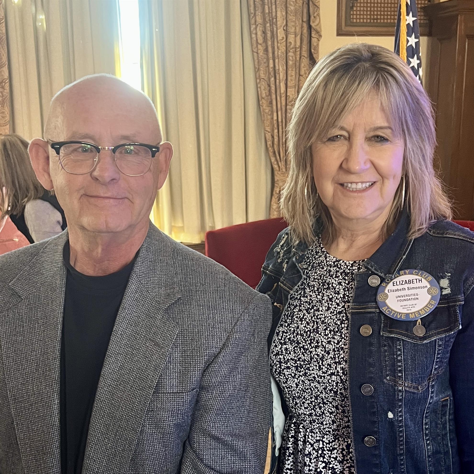 A person and person posing for a pictureAI-generated content may be incorrect.