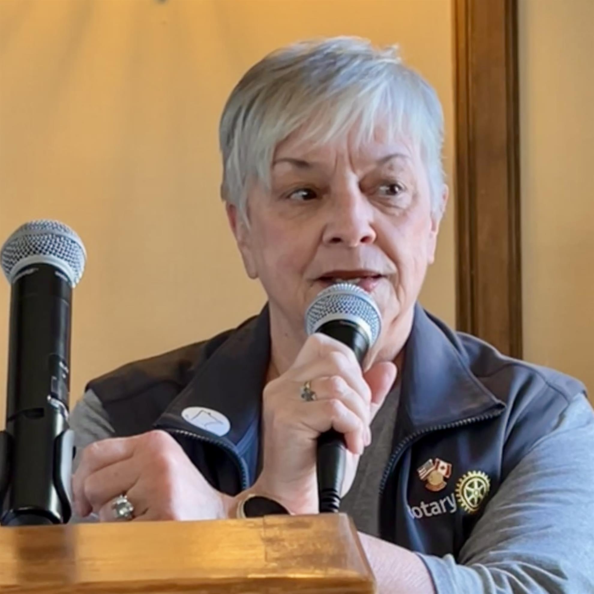 A person speaking into microphonesAI-generated content may be incorrect.