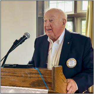 A person standing at a podiumAI-generated content may be incorrect.