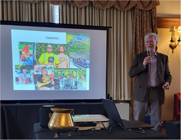 A person standing in front of a projector screenAI-generated content may be incorrect.