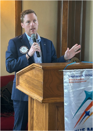 A person speaking into a microphoneAI-generated content may be incorrect.