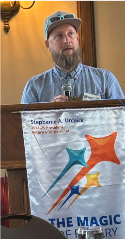 A person sitting at a podiumAI-generated content may be incorrect.