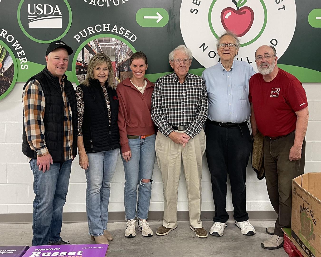 A group of people standing in front of a wallAI-generated content may be incorrect.