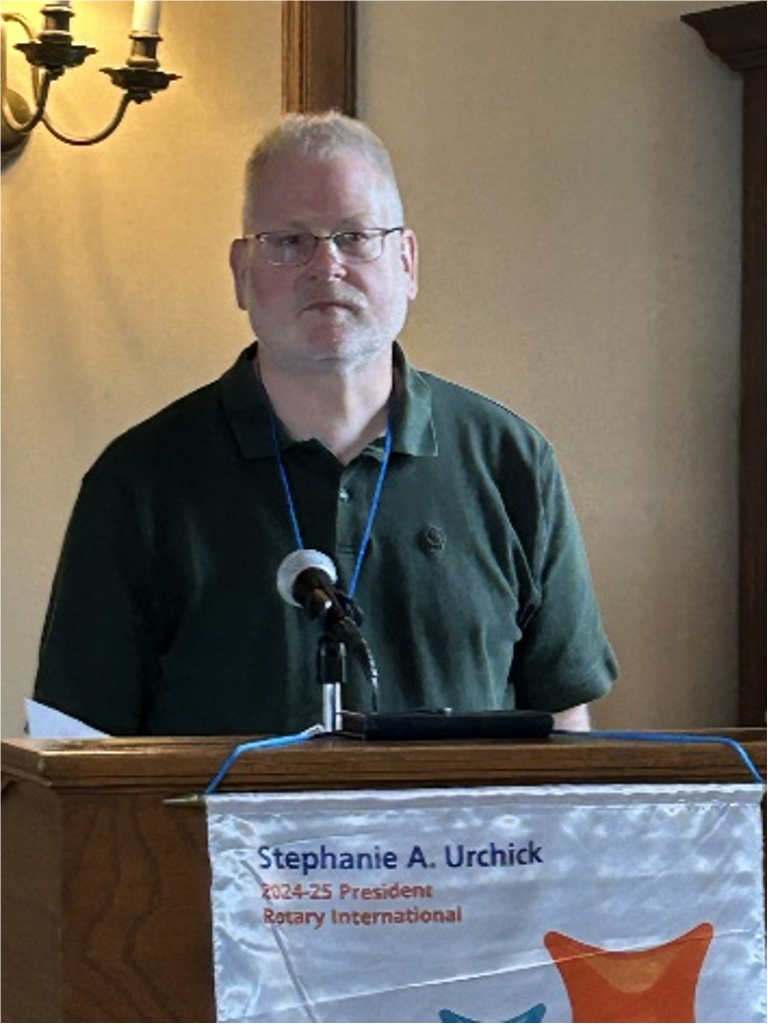 A person standing at a podiumAI-generated content may be incorrect.