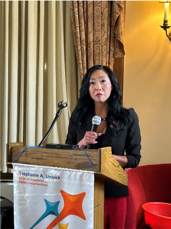 A person standing at a podiumAI-generated content may be incorrect.