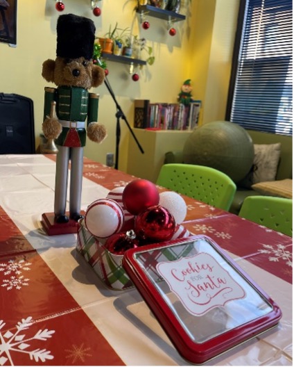 A table with a nutcracker and cookiesDescription automatically generated