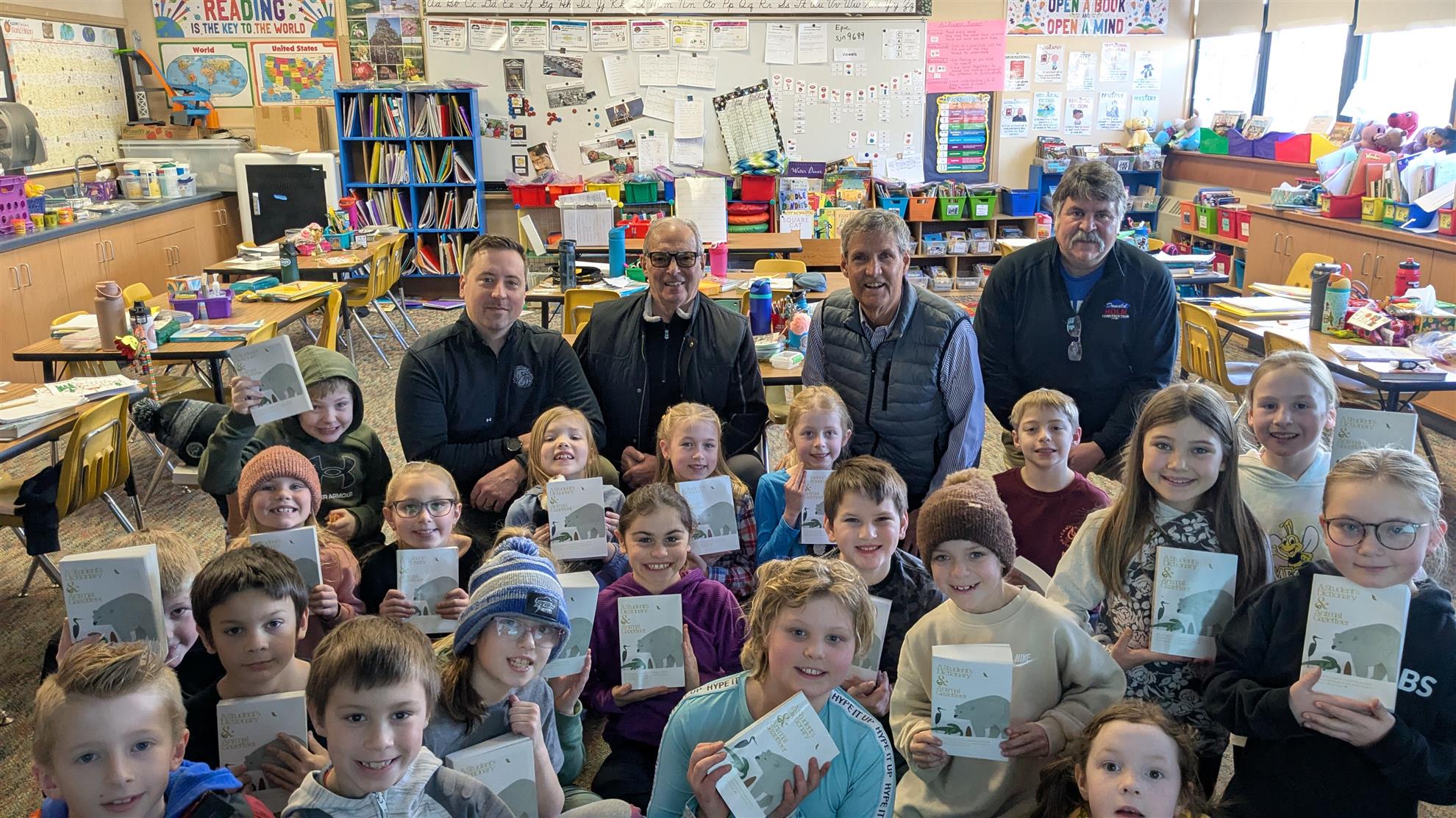 boy in gray sweater beside boy in gray and white plaid dress shirt