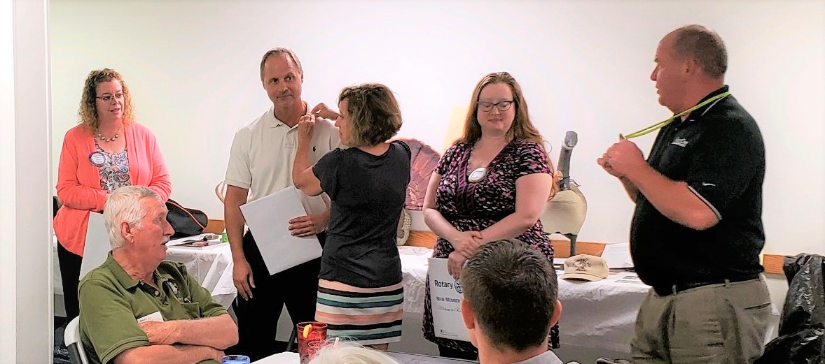 Kent Gagnon (right), assisted by Christy Nowak,swearing in from left to right Missi McPherson, David Washburn and Liz Knap