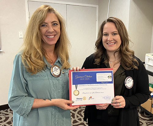 PDG Tina Chapman presenting the District Governor's Citation to  Club President Lindsey Cameron
