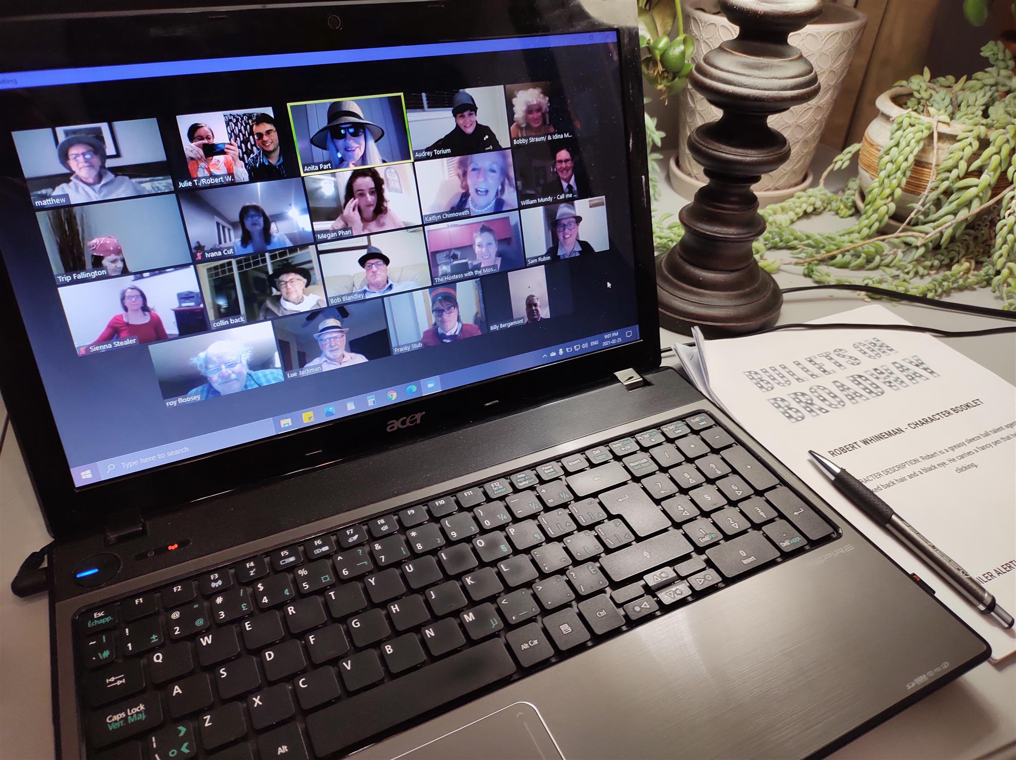 A photo of a laptop screen that displays a video conference of several people in costumes.