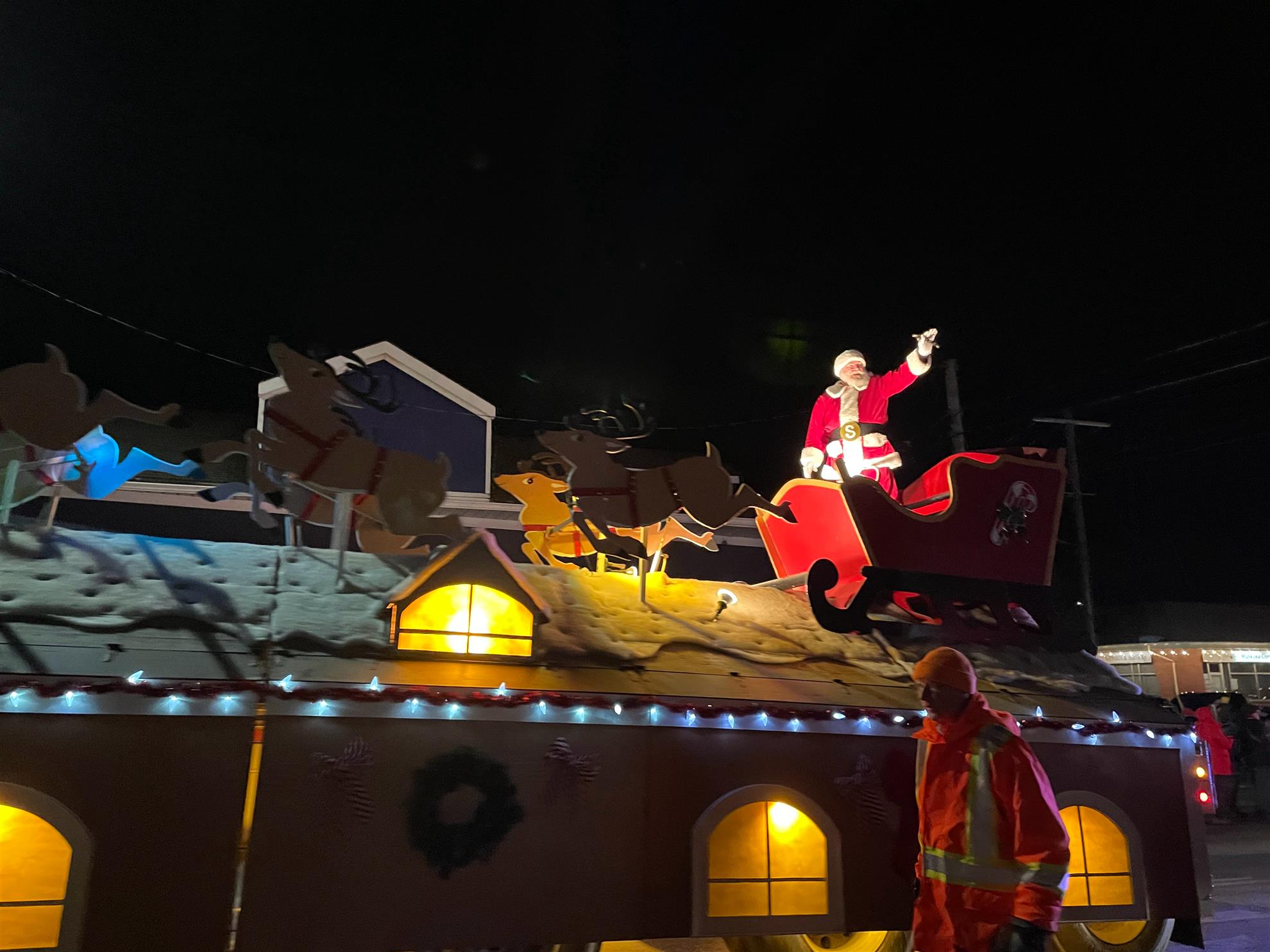 Santa Claus waving to the crowd from a parade float