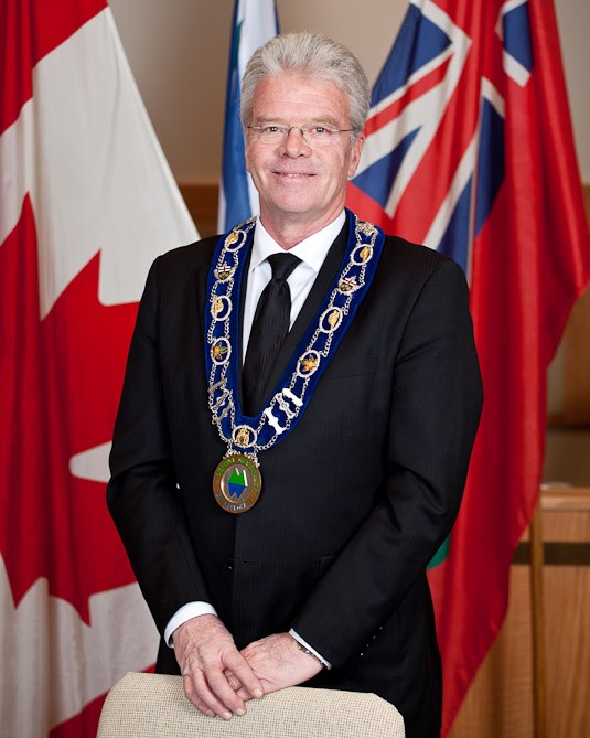 District of Muskoka chair John Klinck wearing his chain of office while standing in the district council chamber