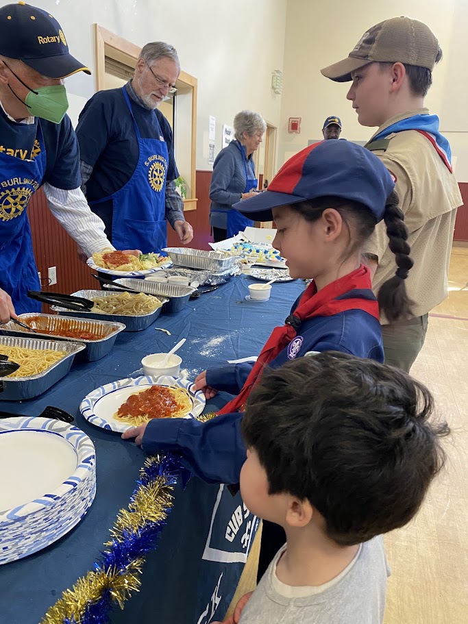 Club members serving up dinner at the Cub Scout Blue and Gold banquet.