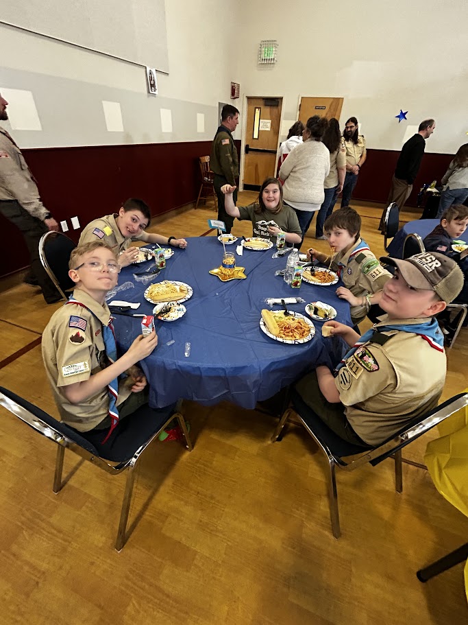 Club members serving up dinner at the Cub Scout Blue and Gold banquet.