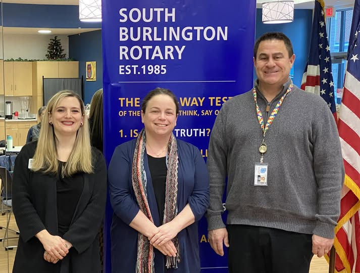 Kristin Dearborn, President, introduces new members Cara Gorman and Joe Clark to the club.