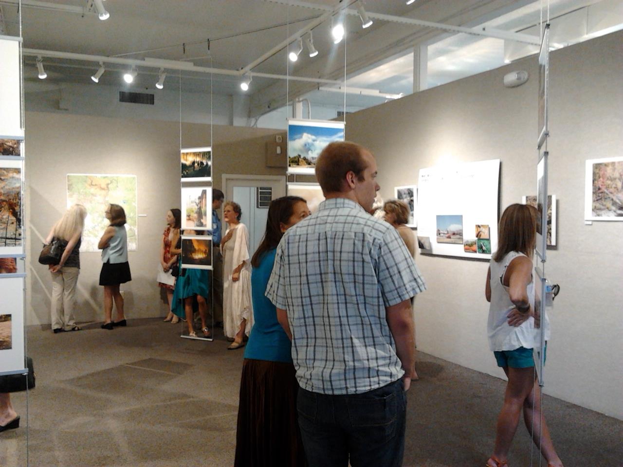 Visitors view photos, art and information about the Slide Fire in Oak Creek Canyon