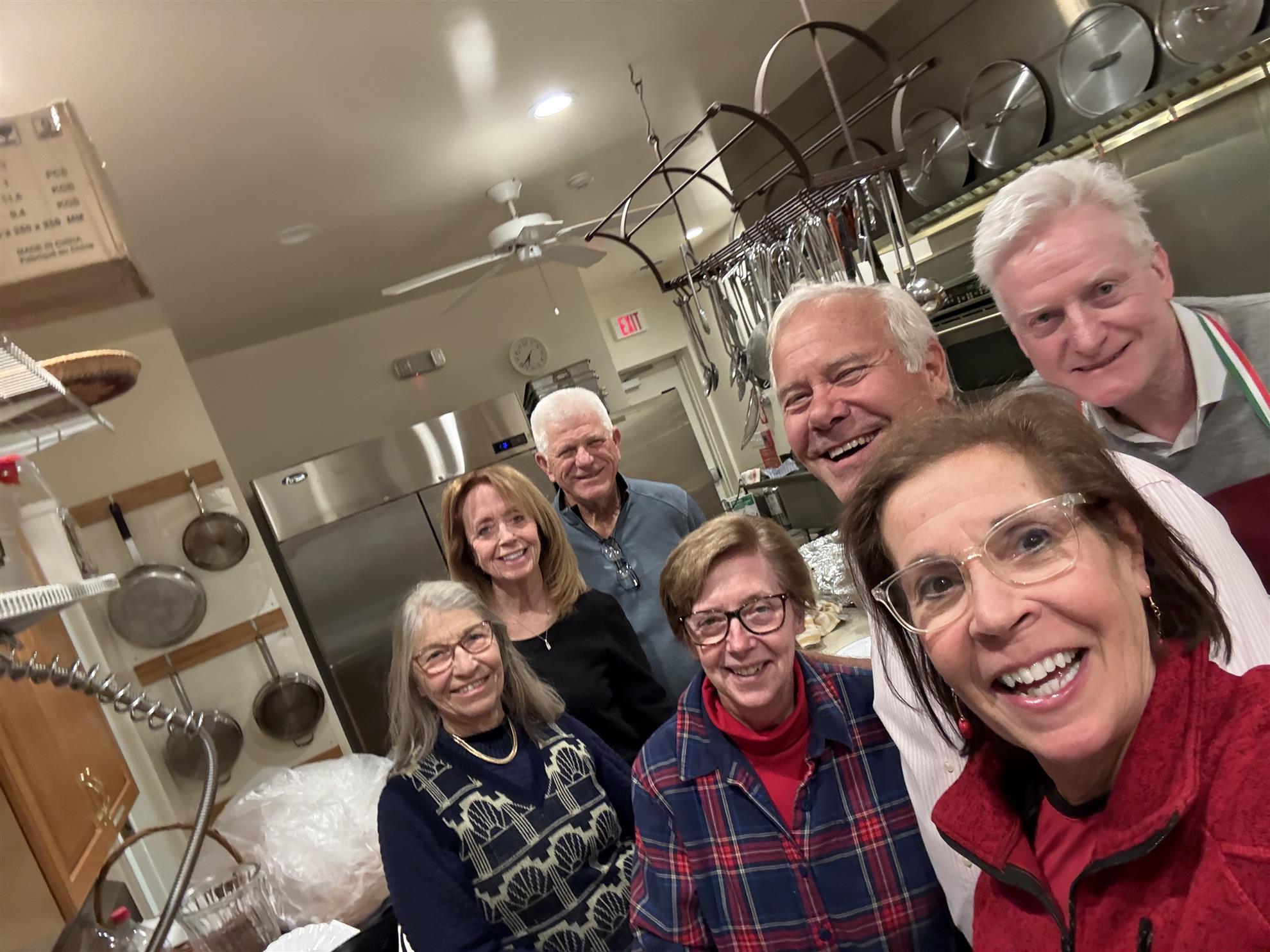 A group of seven people in a commercial kitchen