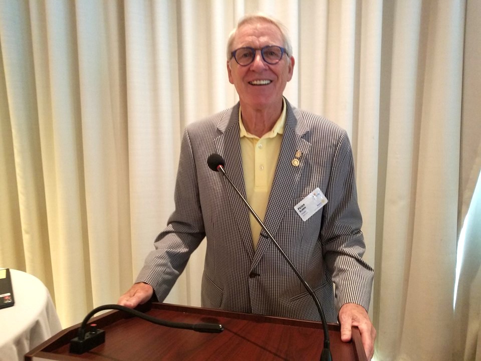 Peter Elmer standing behind the Rotary Club of Lake Forest - Lake Bluff podium