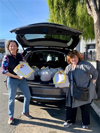 Emily Borland and Nancy Graydon loading meals to be delivered