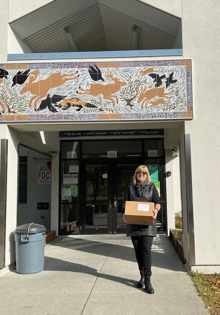 ASR's President Denise Kipke ready to deliver a box full of dictionaries to Anchorage third graders