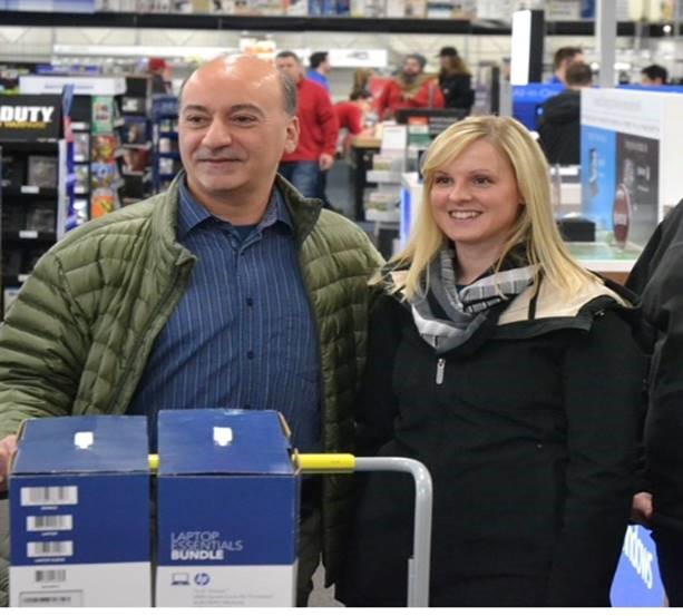 A group of people standing in front of a storeDescription automatically generated