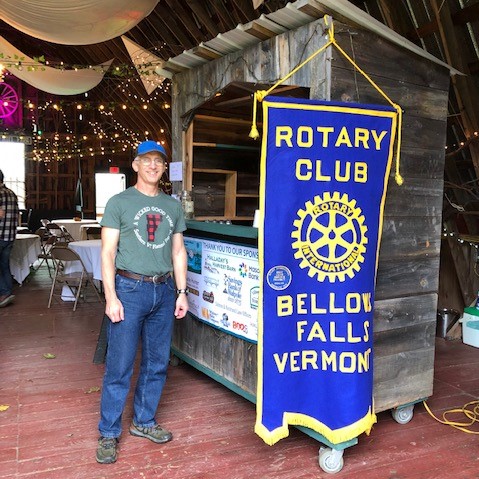Matt models his Flannel Festival t-shirt while guarding the Rotary banner