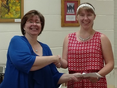 Nicole Murray receives her award from outgoing club president Bonnie Clark on July 7