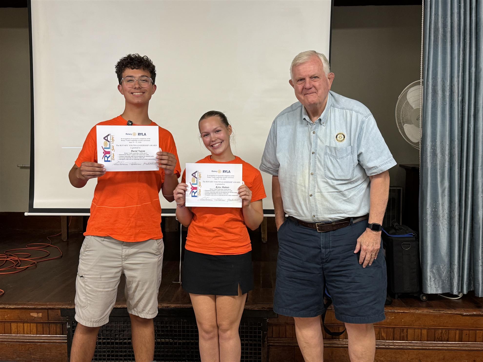 Image of David and Kylee receiving a completion reward for RYLA from Jim McFarlin