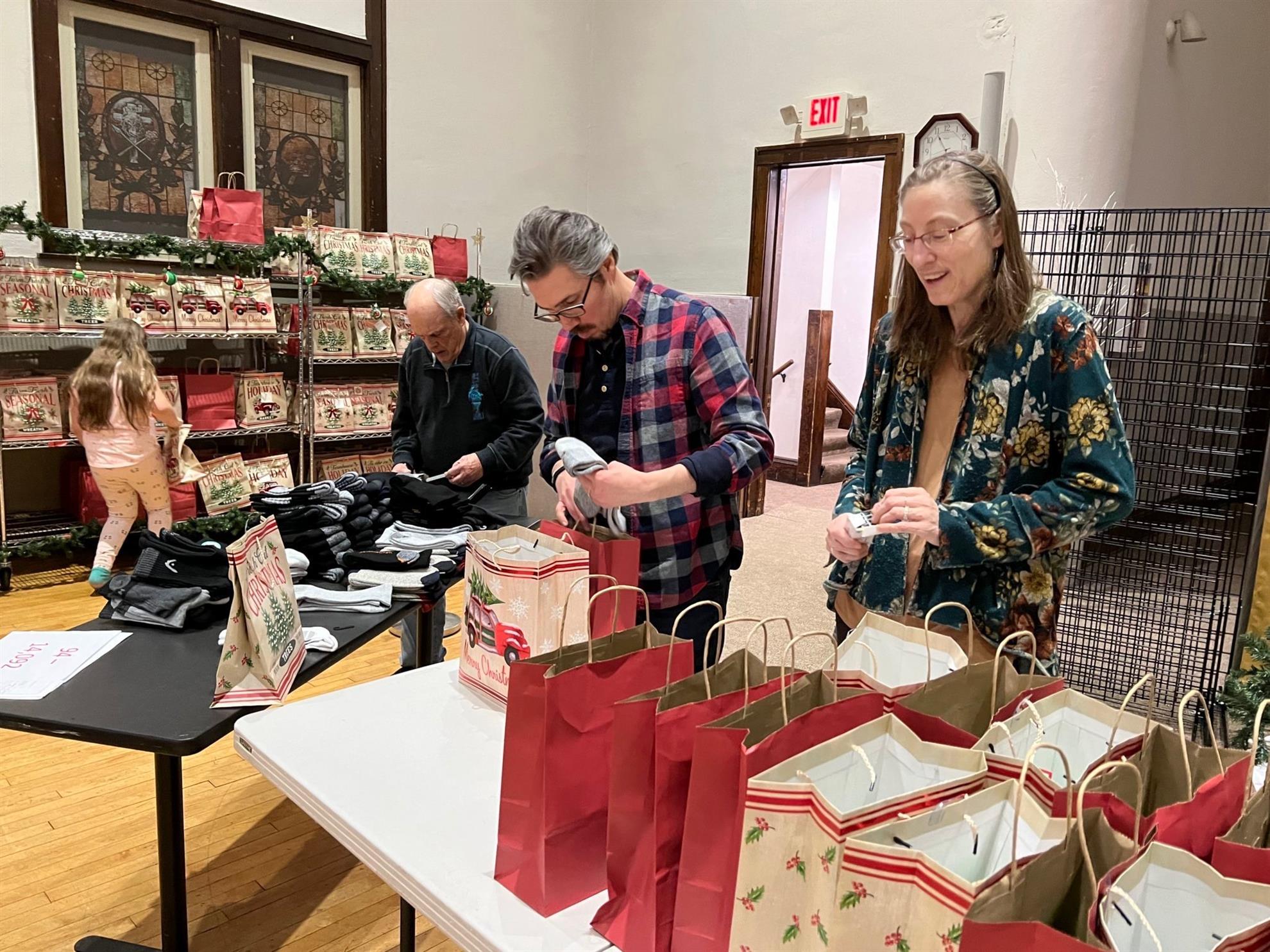 City of Lakes Rotary members pack gift bags for the CES food shelf holiday event.