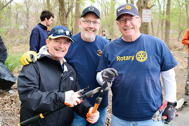 Wielding clippers and saws, club members Kevin Hallinan, Bob Blood and Marty Lindemann removed invasive species from the banks of the Neponset River. 