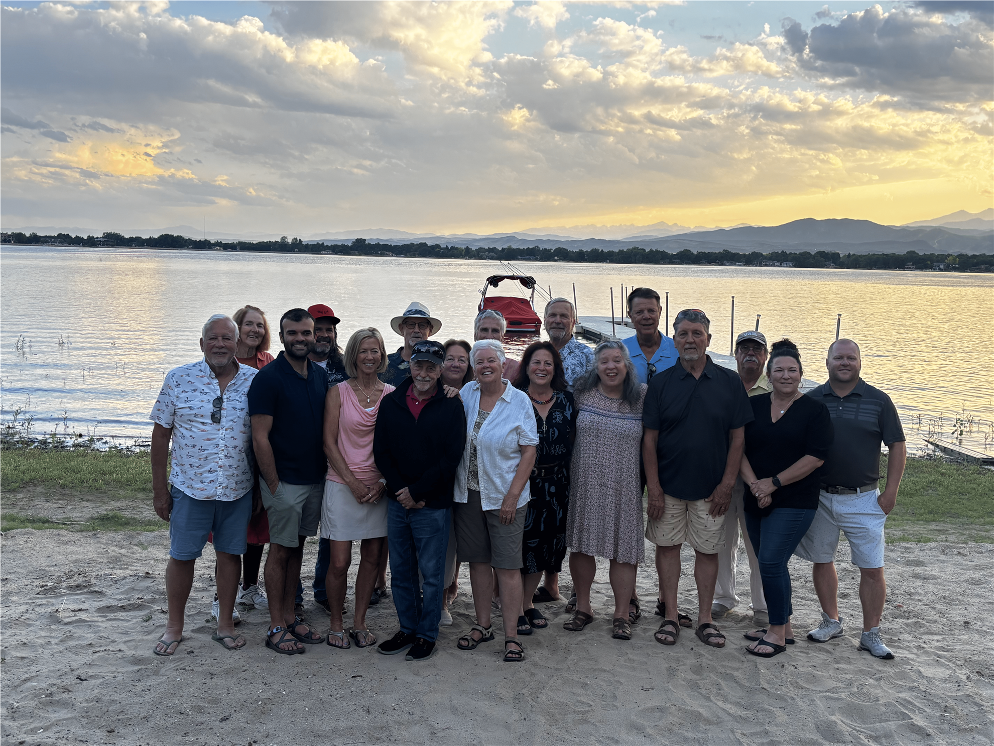Members of the Thompson Valley Rotary Club gather on the shore of Lake Loveland at sunset during the annual 