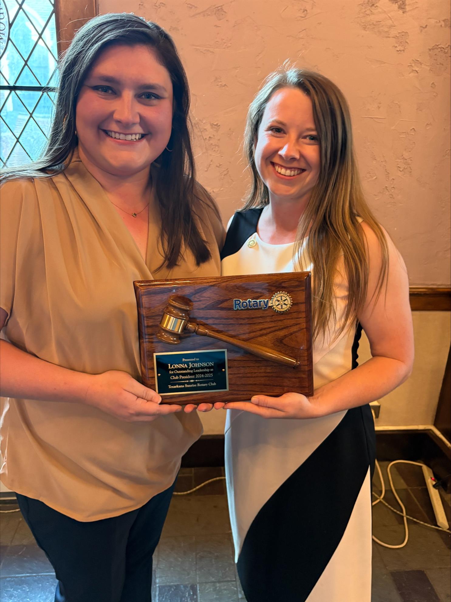PE Megan McMahen presenting President Lonna Johnson with appreciation plaque and PHF +1 pin