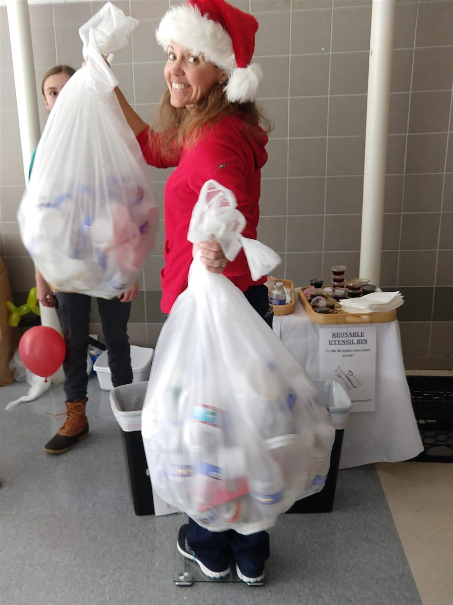 Lisa Warhover weighs the amount of recycling diverted from the landfill