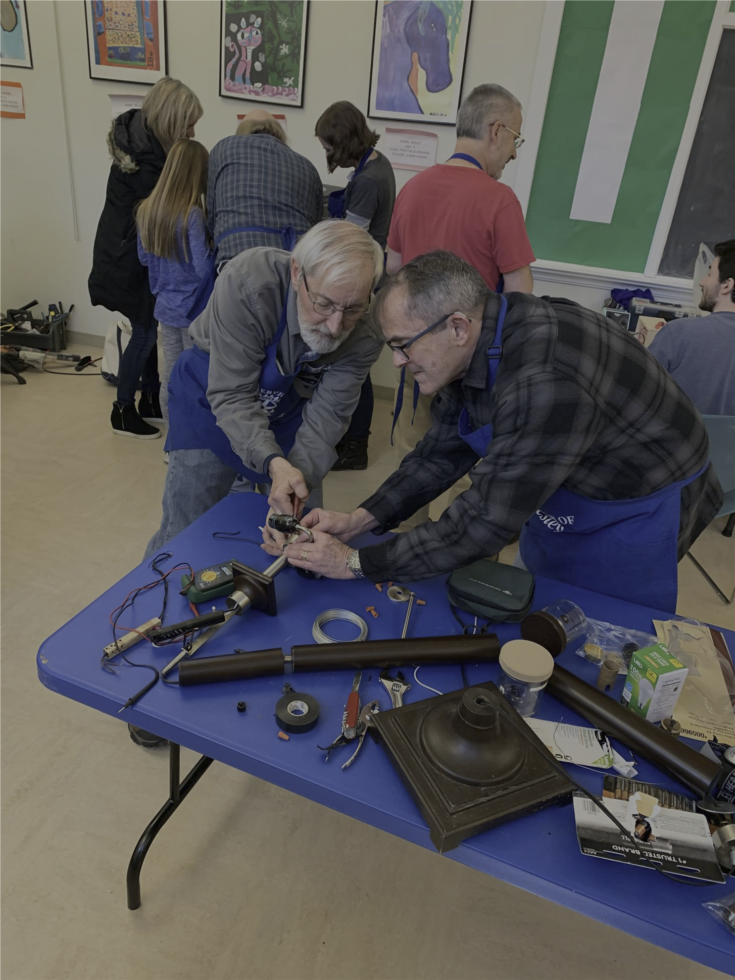 Charlie and Jim repairing a lamp at the Wellesley Repair Café