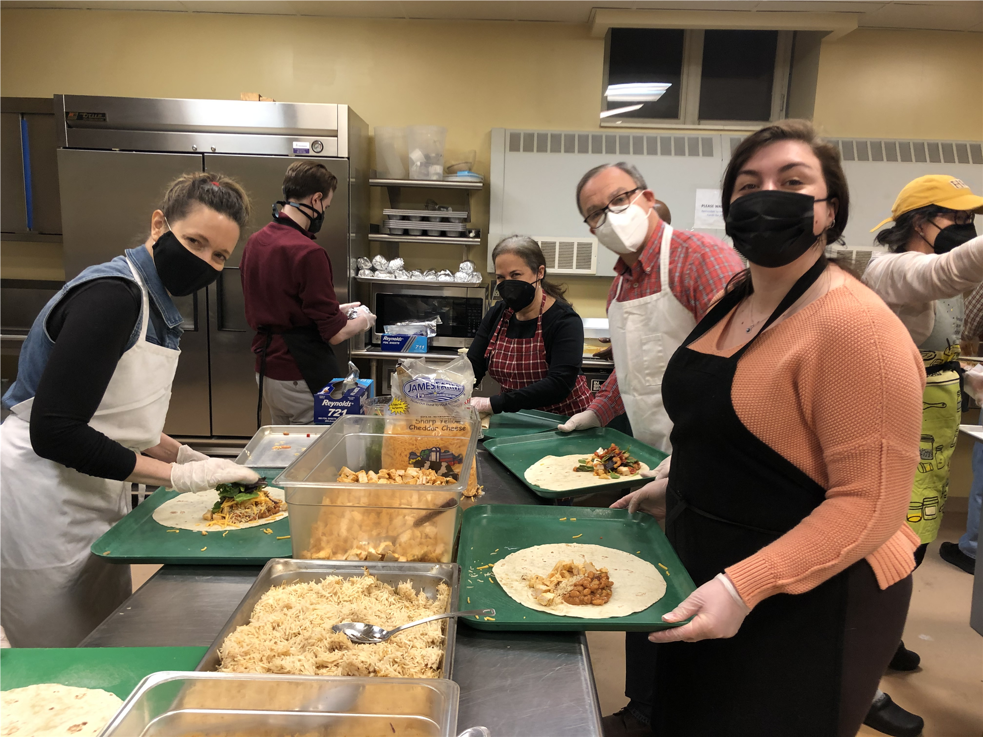 Wellesley Rotary members preparing dinners at the Village Church for veterans