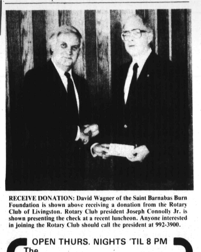Joseph Connolly Jr. presents a Rotary donation to David Wagner of the Saint Barnabas Burn Foundation