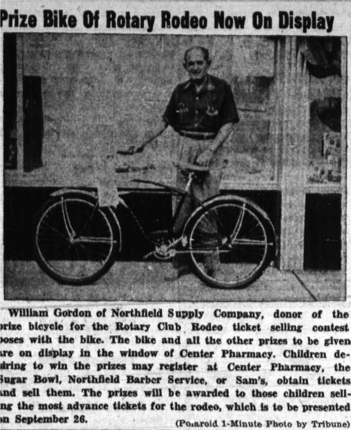 William Gordon of Northfield Supply with the bicycle prize for the rodeo ticket contest