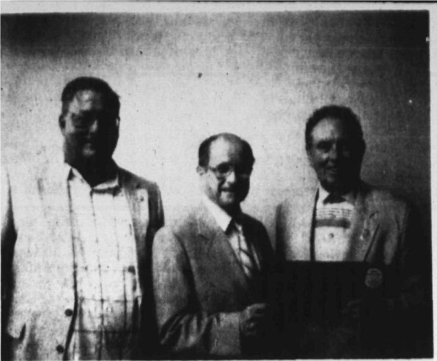 Tony Saggese presents the Paul Harris Award to Kenneth Welch as Robert McCann looks on, 1991