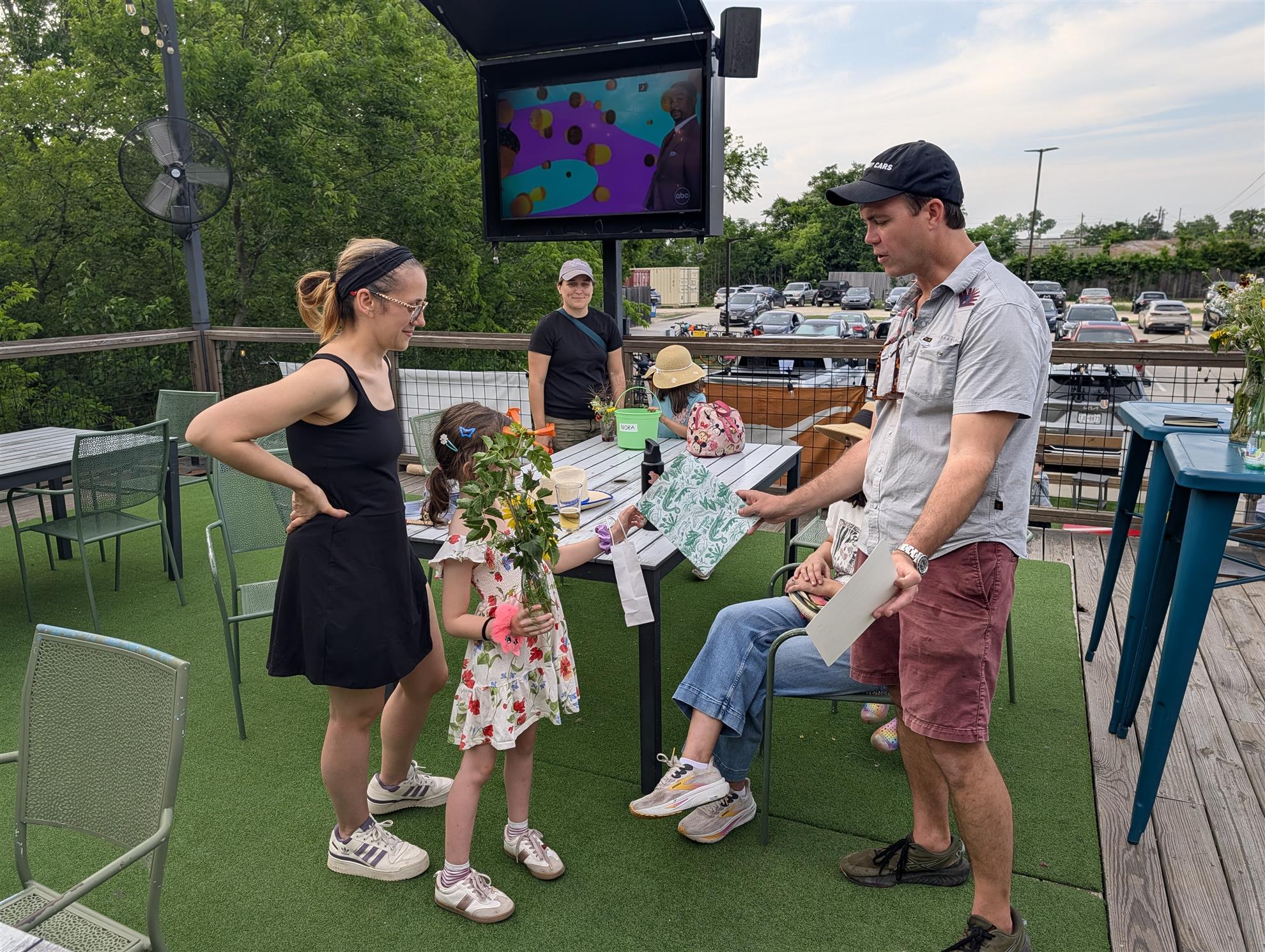 A child receiving their print for winning the bouquet contest.