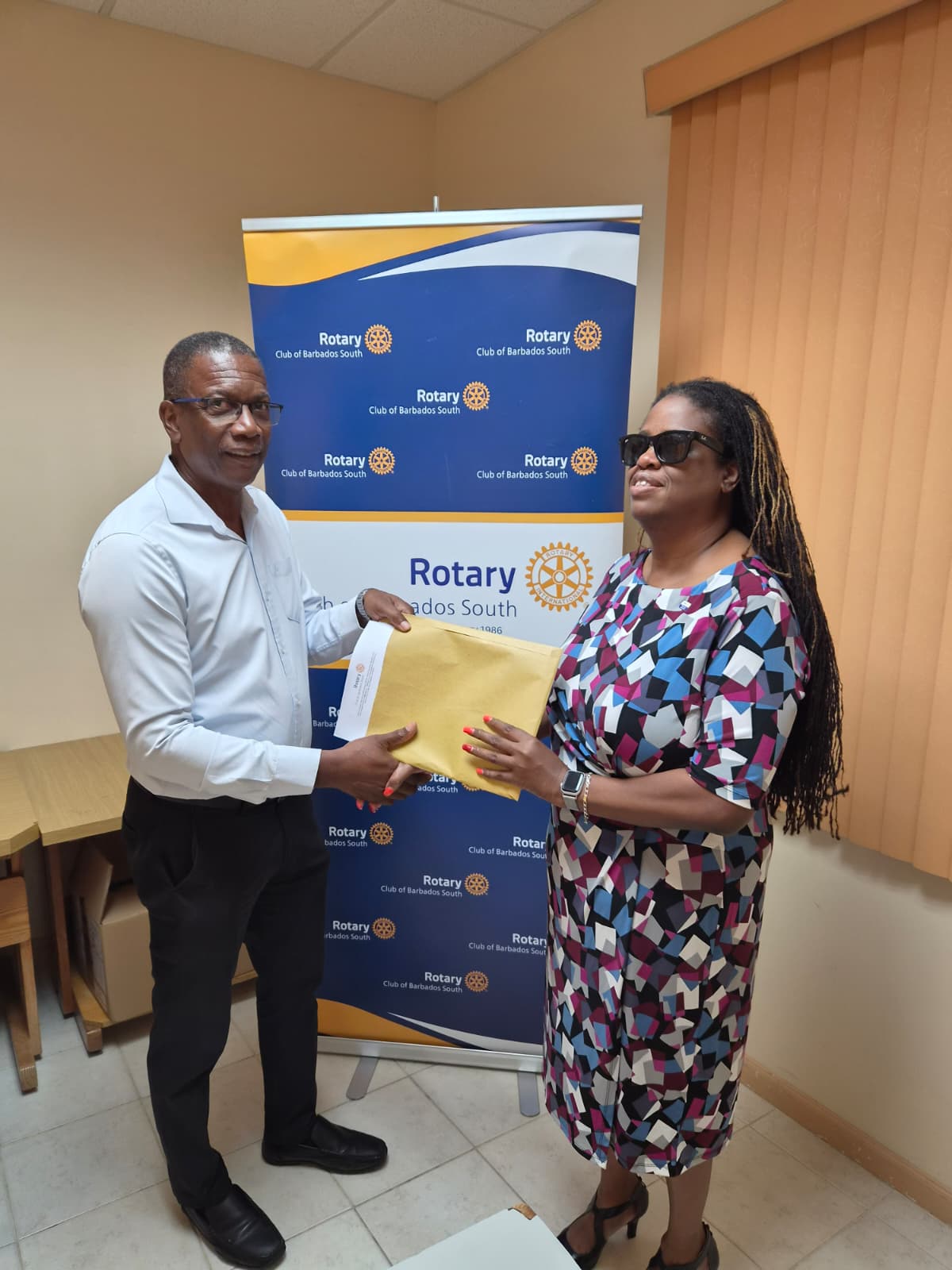 President Kerryann presenting the vouchers to Mr. Colin St. Hill of the SEA