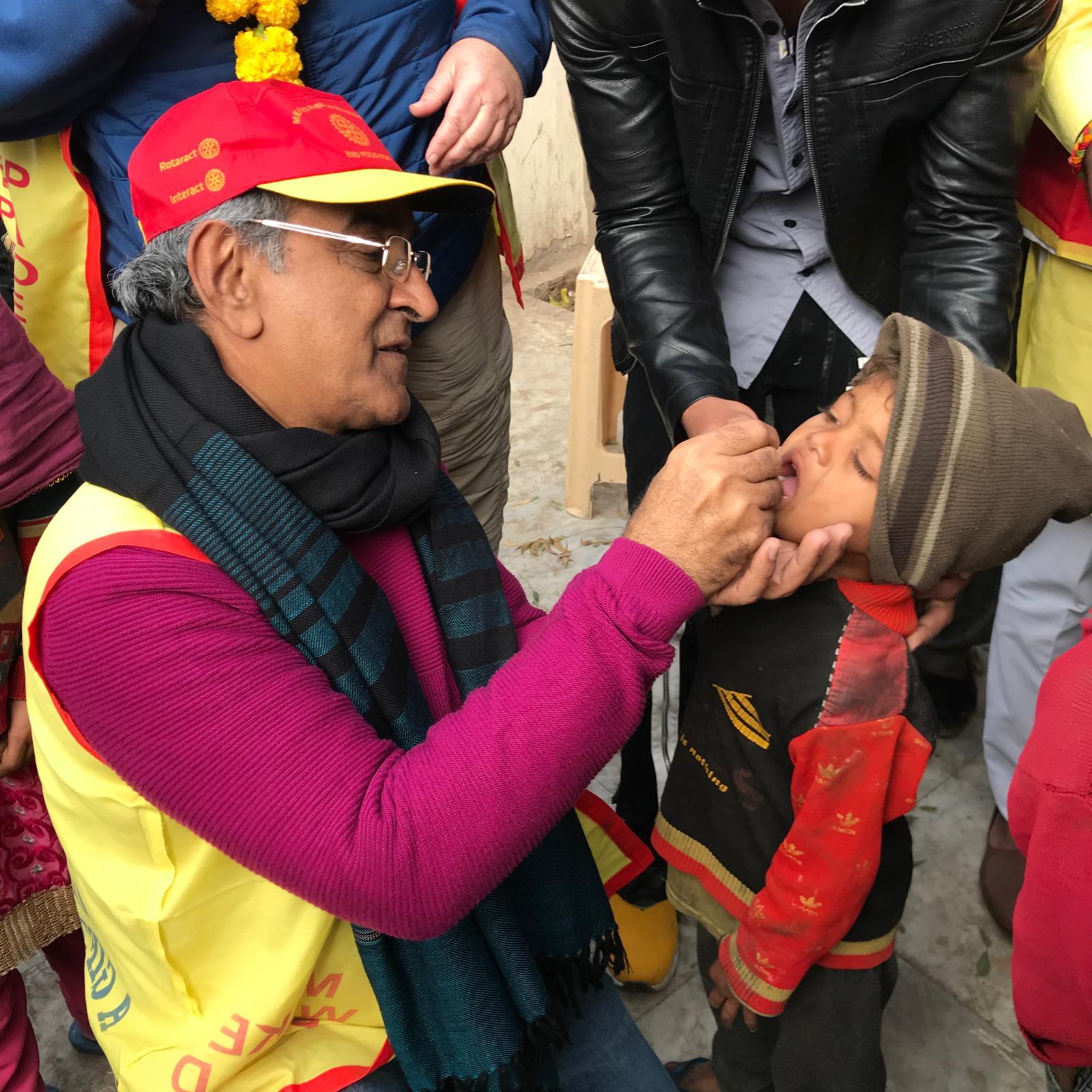 PP Hiro administering polio immunization drops to a toddler