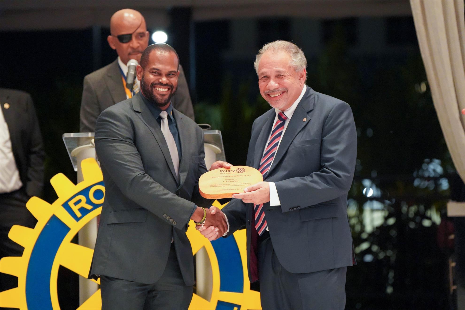 Rtn Courtney Ramsay receiving an award on behalf of his son