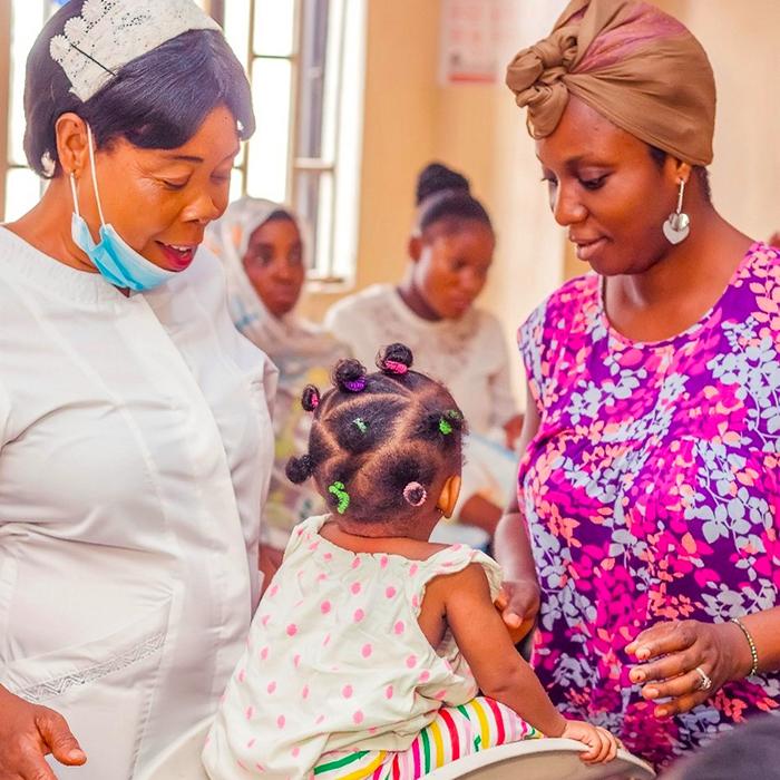 Image of a mother and child getting attention from a nurse