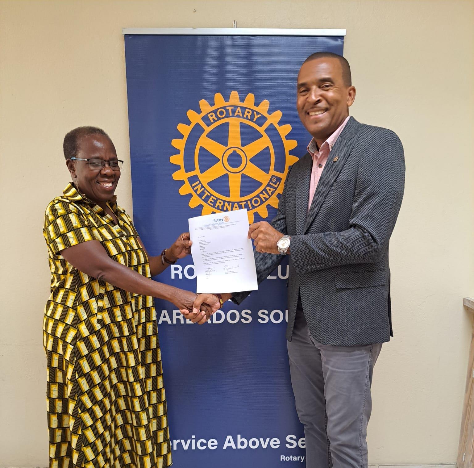 President Marcel Murrell presenting the letters to Child Care Board Director Rose Anne Richards