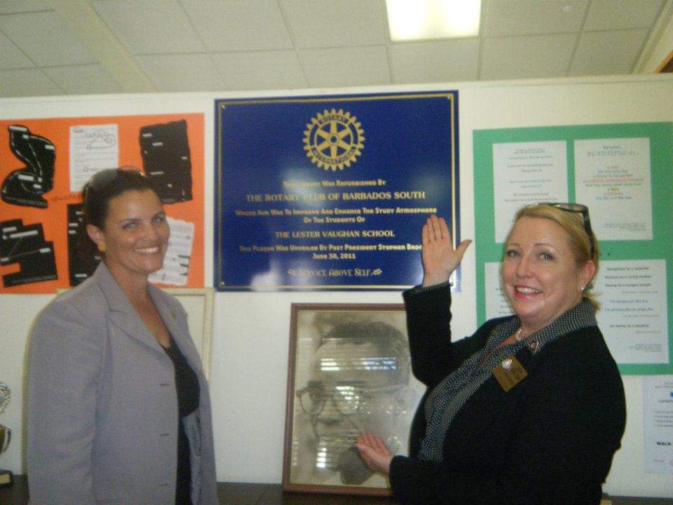 PDG Lara and then President now PDG Sonya at Lester Vaughn Library in front of the commemorative plaque