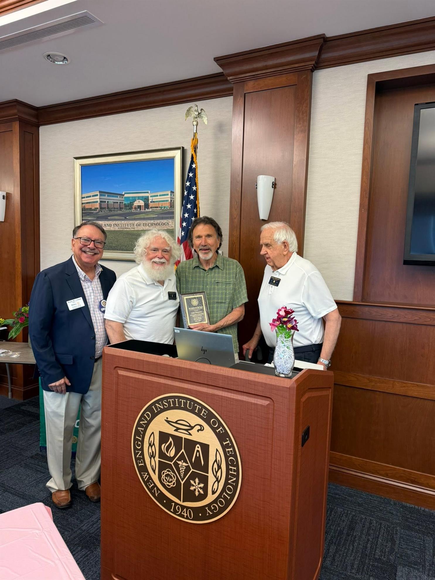 John Wolcott (2nd from left) receives Rotarian of the Year award for 2025-2027