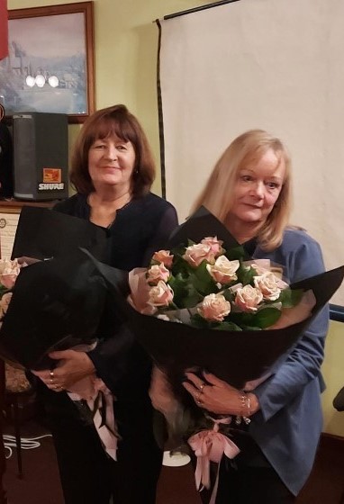Rosie and Hellen receive flowers for a job well done during Covid
