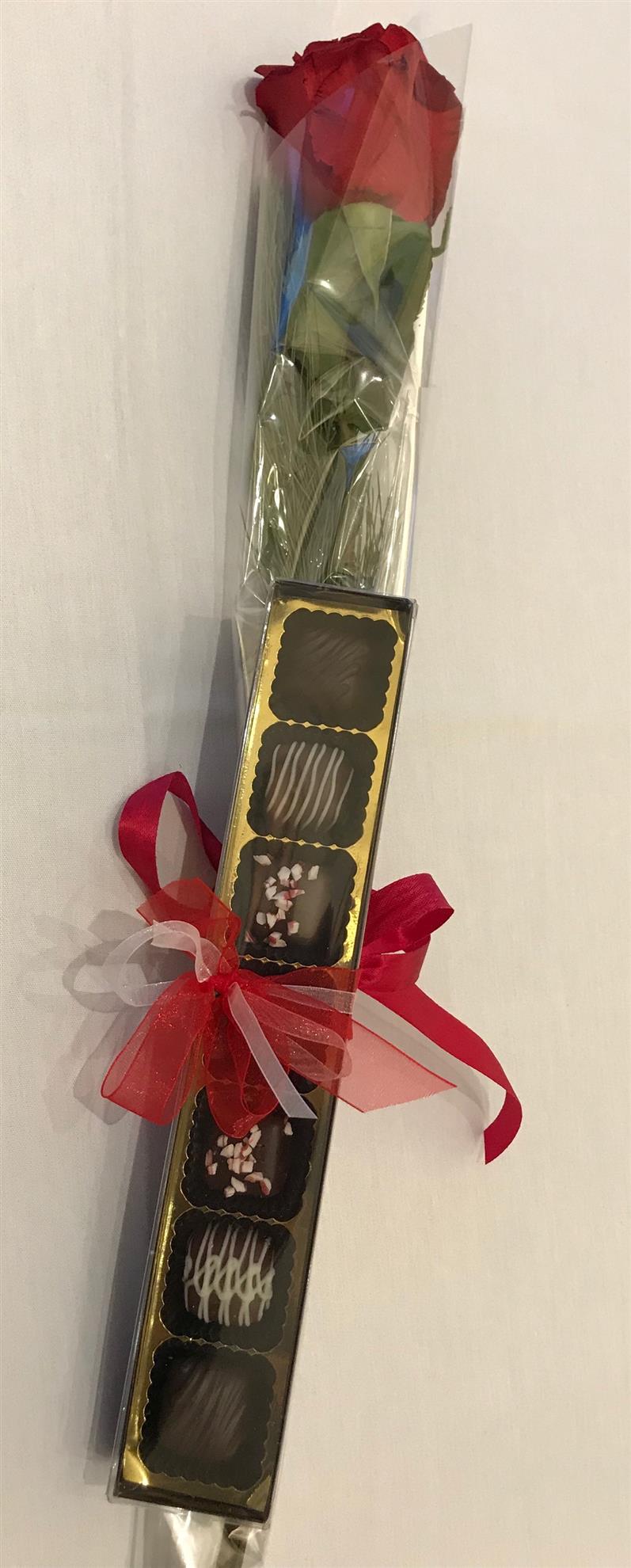 A single red rose with a box of gourmet hand-made chocolates tied with a ribbon.