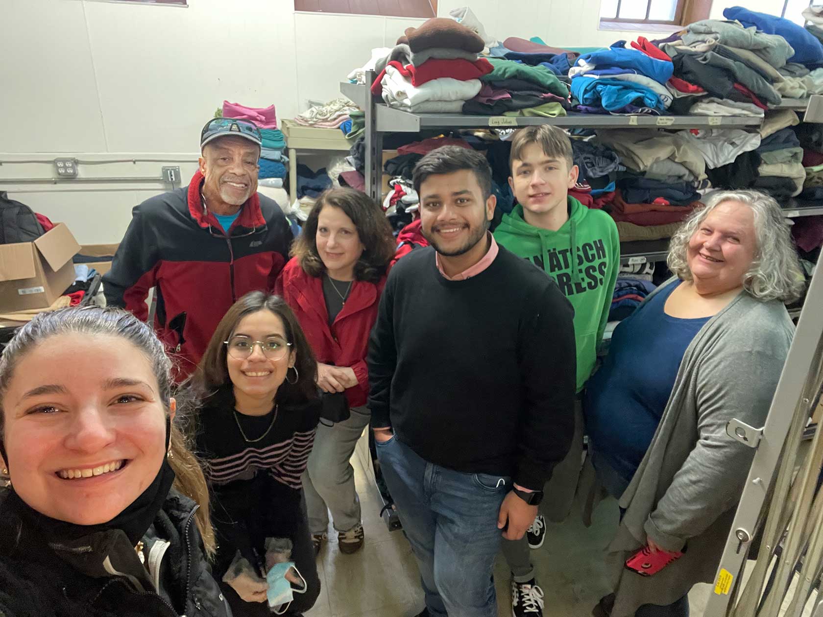 Rotary members and Utica U. students at shelter