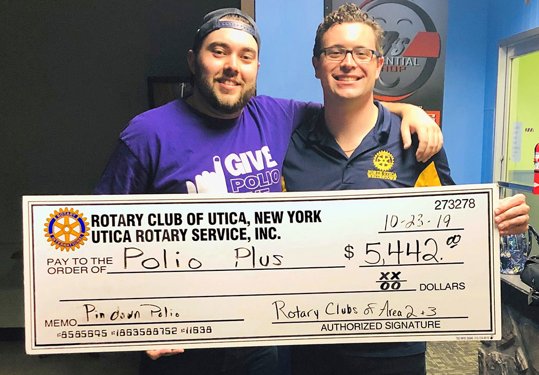 Stephen Turnbull (Rotary Club of Utica) and Steve Karboski (North Utica-Whitestown Rotary) hold ceremonial check showing impact of the bowling fundraiser.